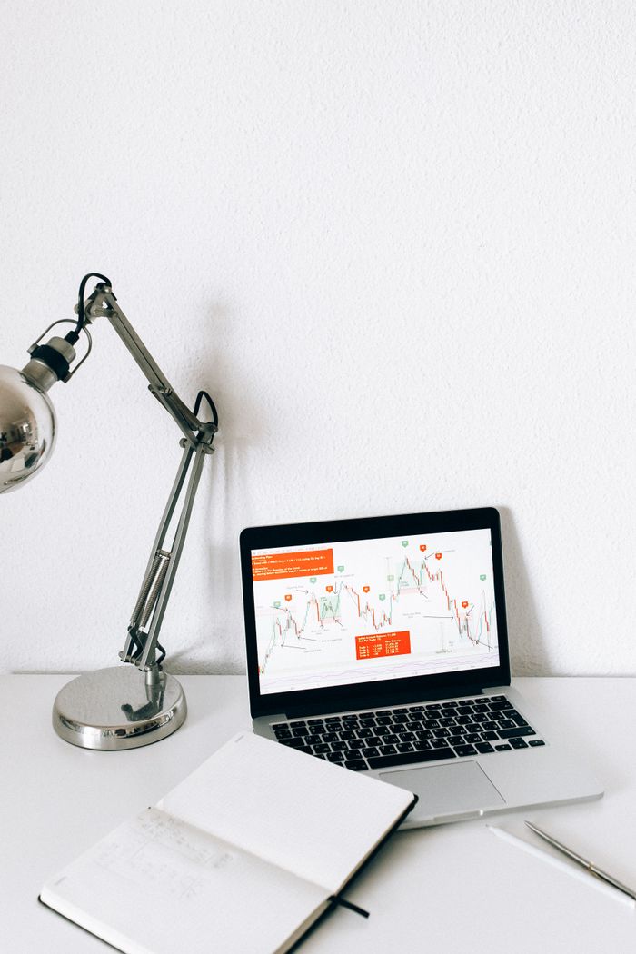A sleek workspace featuring a laptop displaying data analysis charts, perfect for business and technology themes.